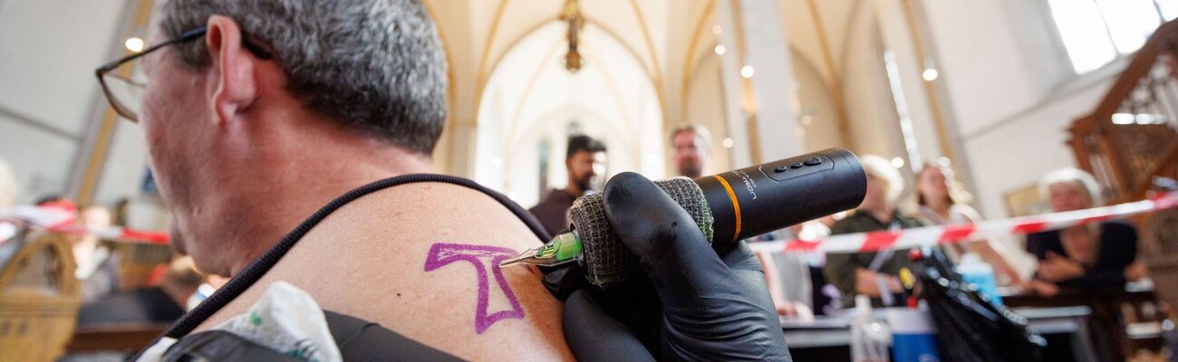 In der Johanniskirche in Osnabrück werden kostenlose Tattoos angeboten., © Friso Gentsch/dpa