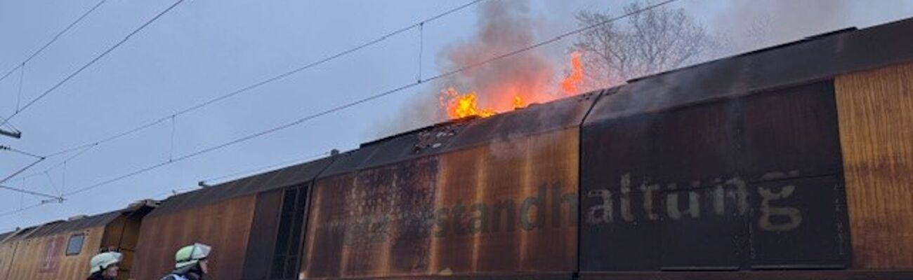 Flammen lodern auf einem Bauzug bei Porta Westfalica. Das sorgt für Umleitungen und Behinderungen im Bahnverkehr. , © Dominik Duensing/Feuerwehr Porta/dpa