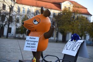 Die von Aktivisten "entführte" Maus protestiert in Magdeburg gegen Kürzungen beim öffentlich-rechtlichen Rundfunk. , © Simon Kremer/dpa